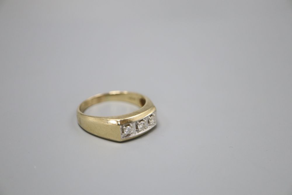 A 9ct. gold three stone diamond ring, larger than size Z, gross 7.3 grams